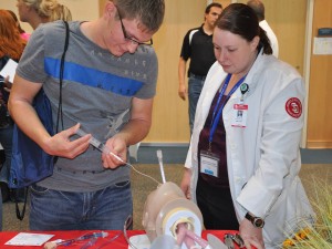 USD Sanford School of Medicine student visits with a high school student during Scrubs Camp 2012 in Yankton.